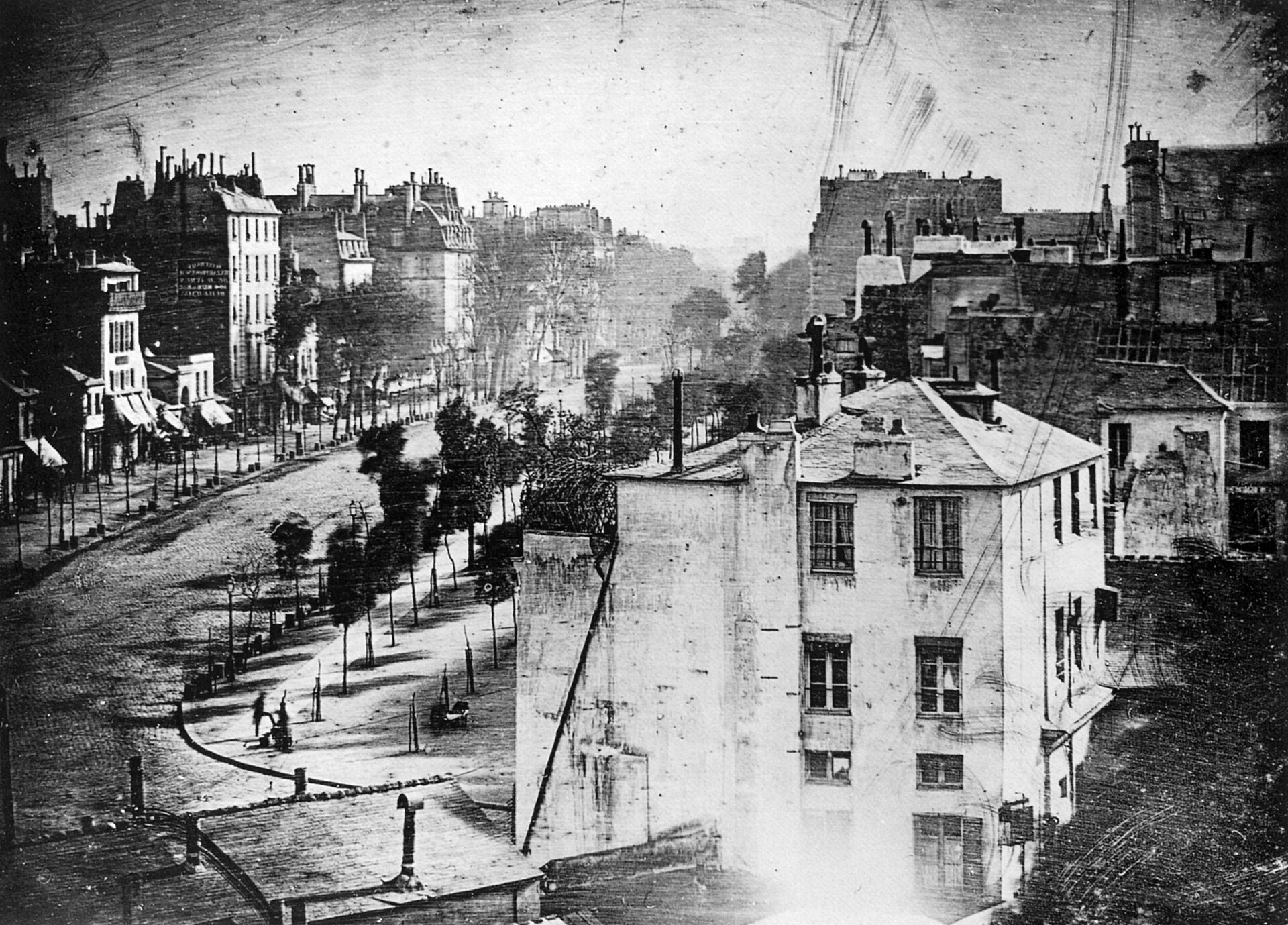 Louis Daguerre's 1838 daguerreotype of the Boulevard du Temple in Paris, an empty-looking street with a single figure standing still enough to be recorded.