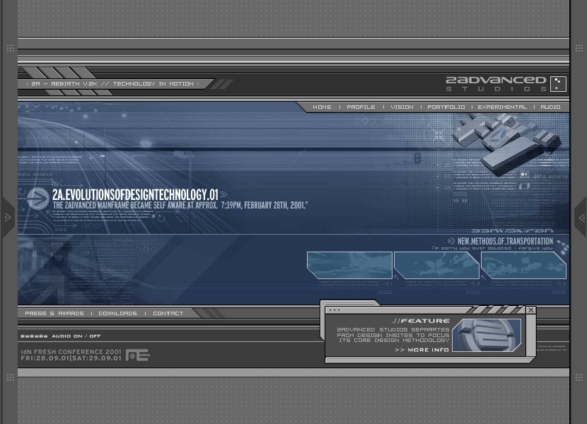A screenshot of the iconic 2Advanced Studios version 2 Flash website from 2001, a dark blue-gray industrial interface with metallic beveled panels, a technical HUD, navigation bar, and thumbnail panels.
