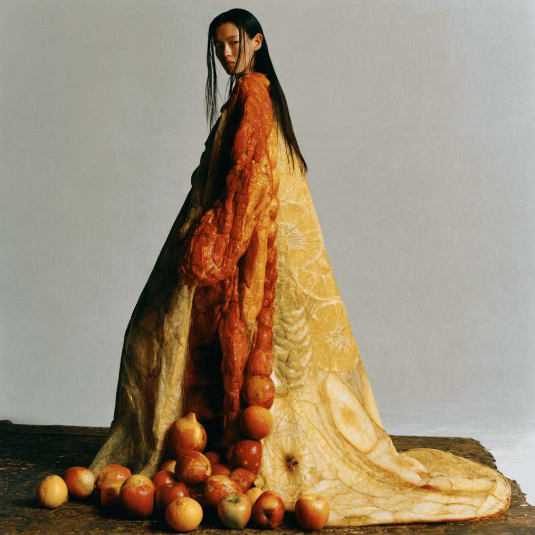 Harvest Collection AI couture editorial by LILU: model in a sculptural gown made of citrus and fruit textures
